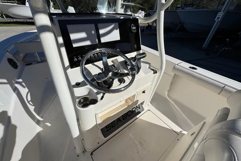 Slide: The Image of 2022 Sea Born LX22 Center Console boat interior with steering wheel and control panel. - 32