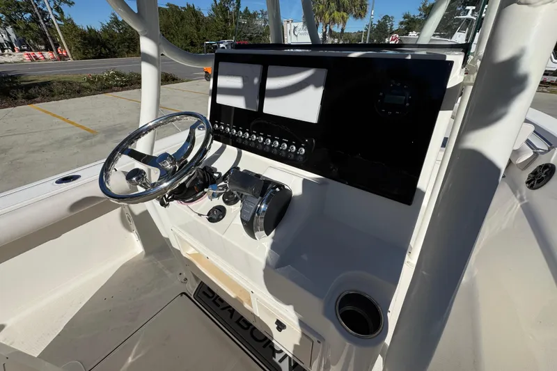 Slide: The Image of 2022 Sea Born LX22 Center Console boat dashboard with steering wheel and controls. - 35