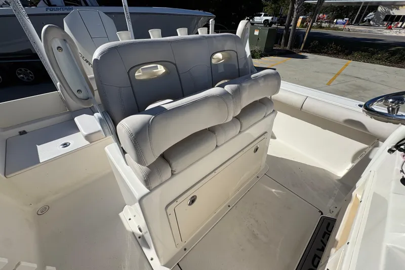 Slide: The Image of 2022 Sea Born LX22 Center Console boat interior with cushioned seating and storage. - 36