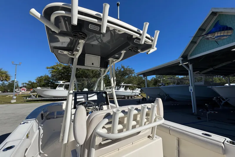 Slide: The Image of 2022 Sea Born LX22 Center Console boat with rod holders and T-top in marina setting. - 38
