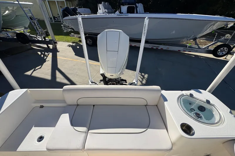 Slide: The Image of 2022 Sea Born LX22 Center Console boat with seating and motor, parked on a trailer. - 40