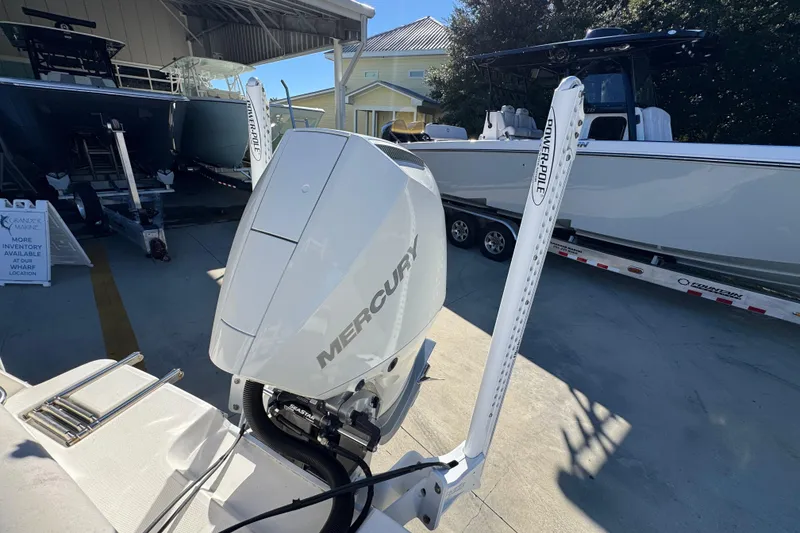 Slide: The Image of 2022 Sea Born LX22 Center Console with Mercury engine and Power-Pole, displayed outdoors. - 43
