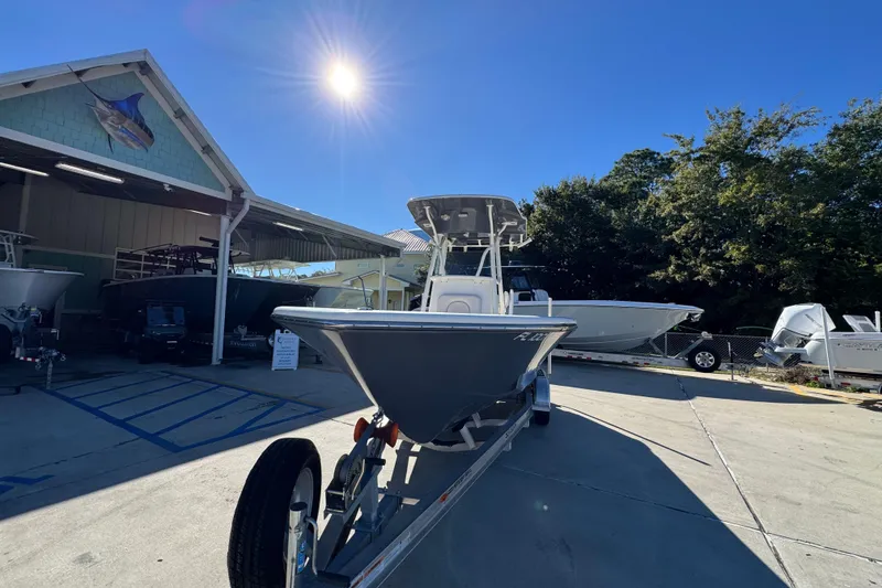 Slide: The Image of 2022 Sea Born LX22 Center Console boat on trailer under bright sun. - 5