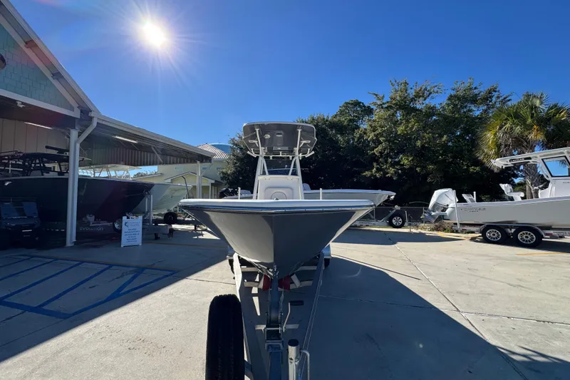 Slide: The Image of 2022 Sea Born LX22 Center Console boat displayed outdoors under bright sun. - 6