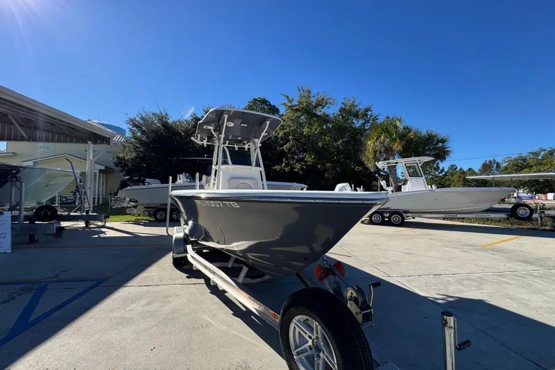 Slide: The Image of 2022 Sea Born LX22 Center Console boat on trailer in sunny outdoor setting. - 7