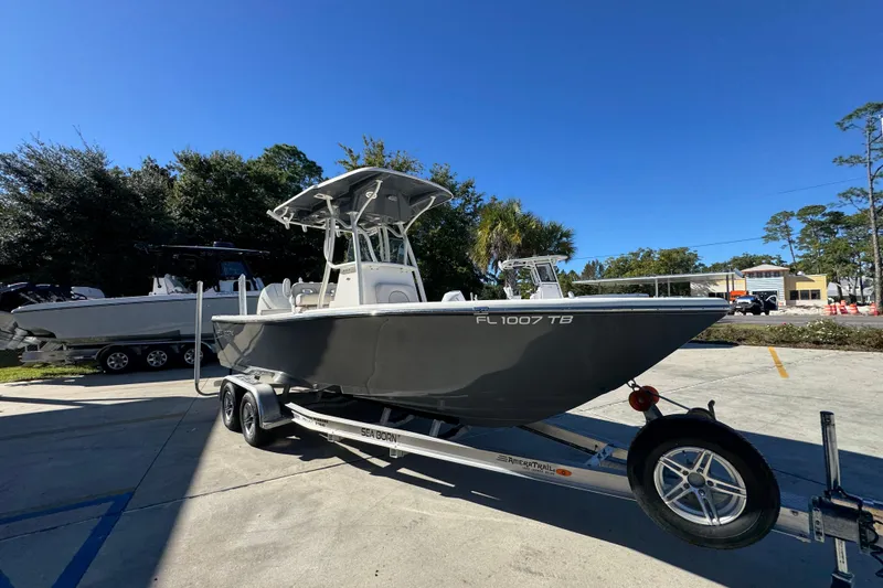 Slide: The Image of 2022 Sea Born LX22 Center Console boat on trailer in sunny outdoor setting. - 8