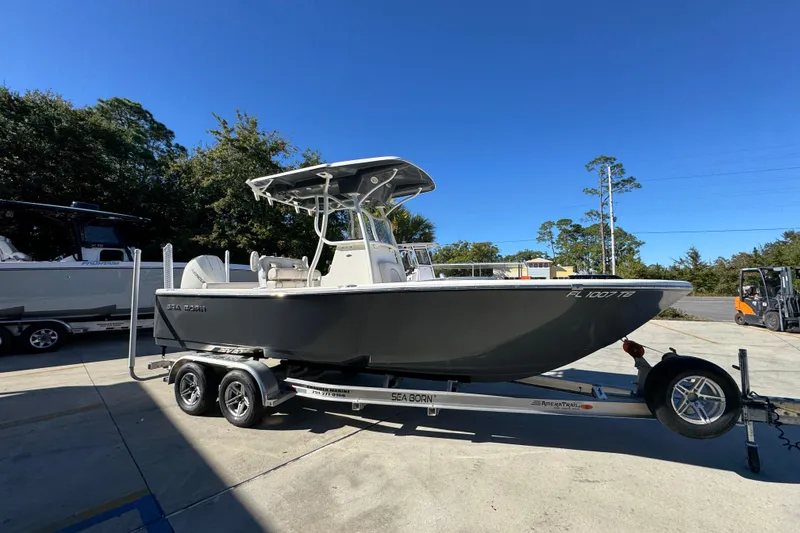 Slide: The Image of 2022 Sea Born LX22 Center Console boat on trailer in sunny outdoor setting. - 9