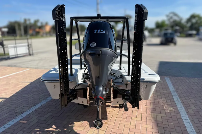 Slide: The Image of 2026 Action Craft 17 FLYFISHER boat with powerful outboard motor, parked on brick pavement. - 1