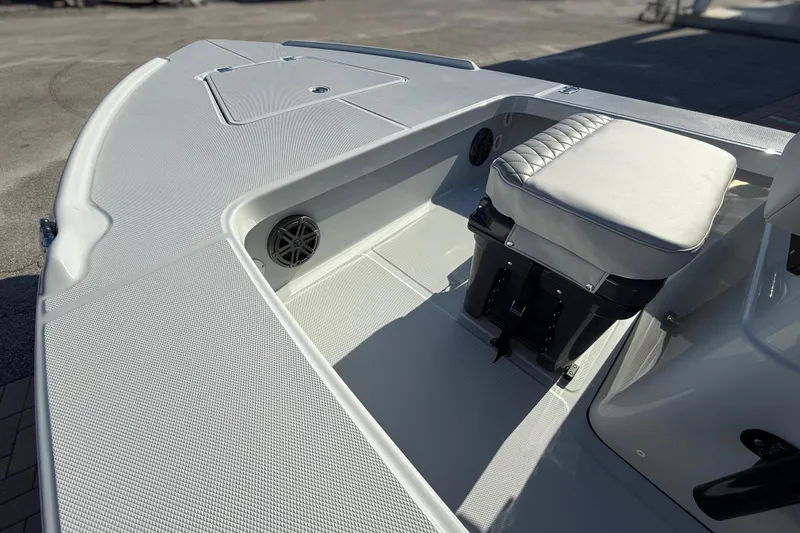 Slide: The Image of 2026 Action Craft 17 FLYFISHER boat interior with cushioned seat and storage compartment. - 12