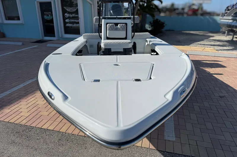 Slide: The Image of 2026 Action Craft 17 FLYFISHER boat displayed outdoors on brick pavement. - 2