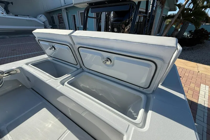 Slide: The Image of 2026 Action Craft 17 FLYFISHER boat with open storage compartments, docked outdoors. - 9