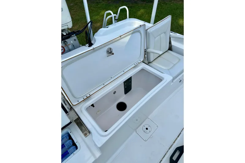 Slide: The Image of Open storage compartment on 2017 Blue Wave 2400 PureBay boat, featuring white seating and clean design. - 12