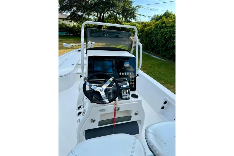 Slide: The Image of 2017 Blue Wave 2400 PureBay boat console with steering wheel and controls. - 14