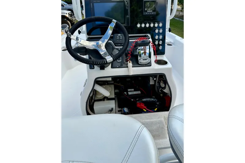 Slide: The Image of 2017 Blue Wave 2400 PureBay boat console with steering wheel and control panel. - 17