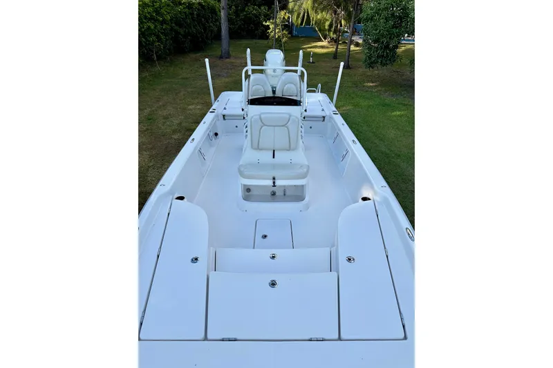Slide: The Image of 2017 Blue Wave 2400 PureBay boat interior with white seating and storage compartments. - 3