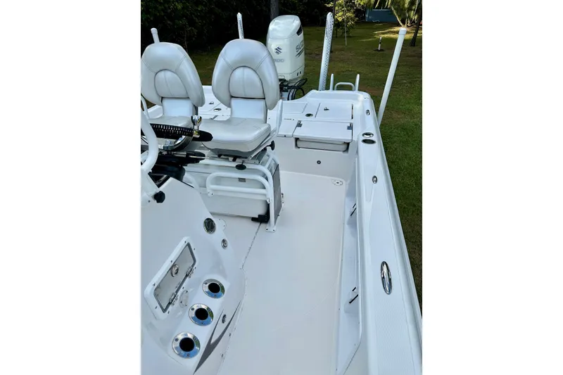 Slide: The Image of 2017 Blue Wave 2400 PureBay boat interior with white seating and deck. - 7