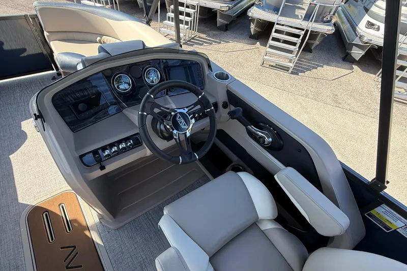 Slide: The Image of 2026 Avalon 2385 LSZ Quad Lounger boat interior with steering wheel and control panel. - 21
