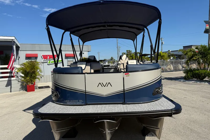 Slide: The Image of 2026 Avalon 2385 LSZ Quad Lounger Tri Toon boat, high performance, parked outdoors. - 3