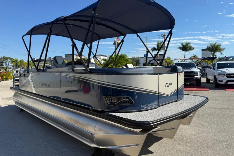 Slide: The Image of 2026 Avalon 2385 LSZ Quad Lounger Tri Toon boat with canopy in a sunny outdoor setting. - 4