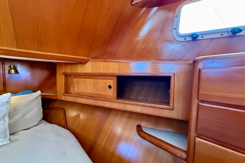 Slide: The Image of Cozy cabin interior of 1997 Offshore Yachts 48 Sedan with wooden finish and window. - 17