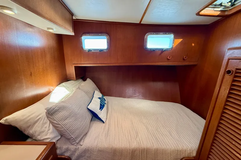 Slide: The Image of Cozy cabin interior of 1997 Offshore Yachts 48 Sedan with wooden finish and porthole windows. - 24