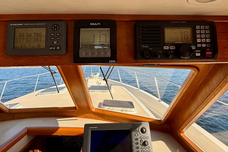 Slide: The Image of Interior view of 1997 Offshore Yachts 48 Sedan with navigation instruments and ocean view. - 34