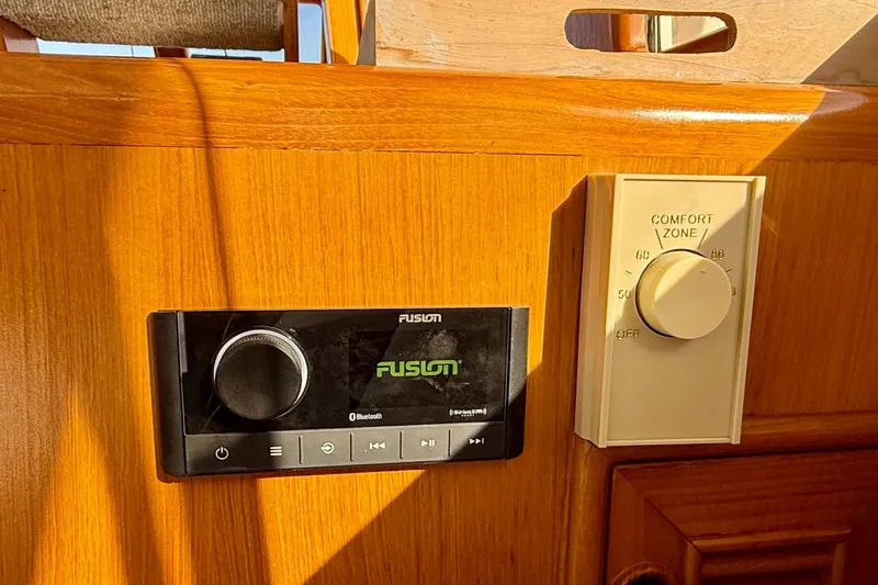 Slide: The Image of Fusion stereo and thermostat controls on 1997 Offshore Yachts 48 Sedan. - 43