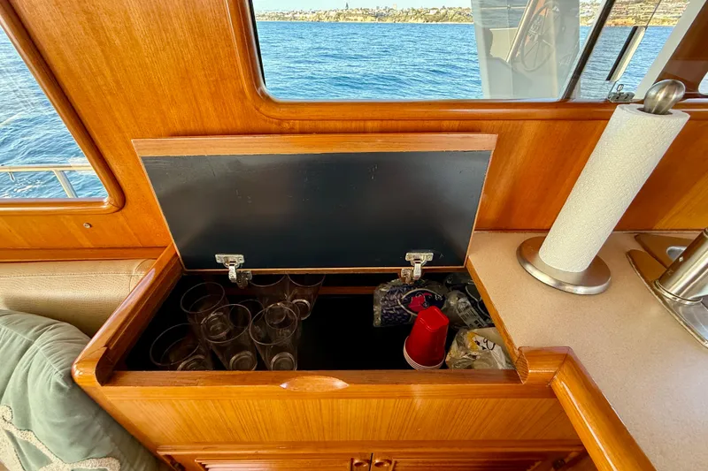 Slide: The Image of Interior of 1997 Offshore Yachts 48 Sedan with storage compartment and ocean view. - 44