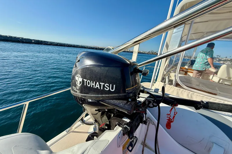 Slide: The Image of 1997 Offshore Yachts 48 Sedan with Tohatsu outboard motor on a sunny day at sea. - 75