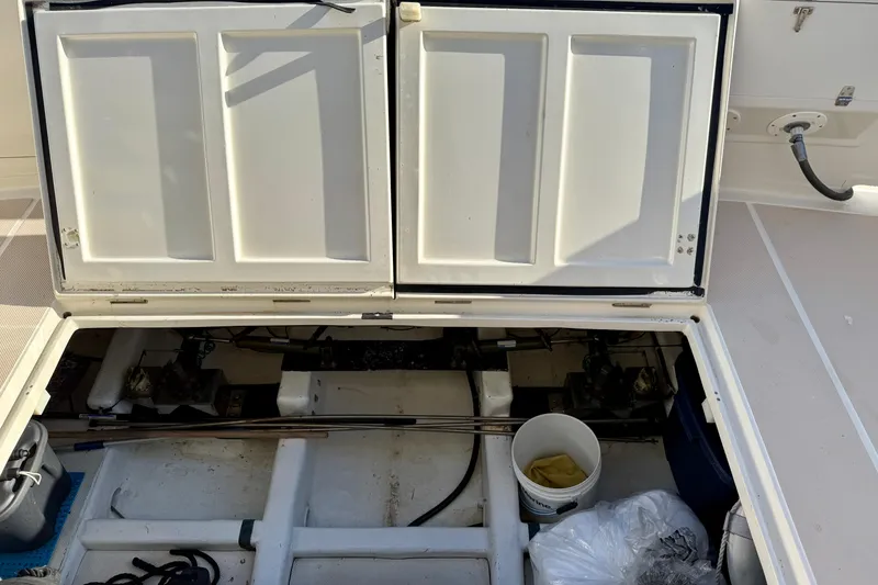 Slide: The Image of Open engine compartment of 1997 Offshore Yachts 48 Sedan, showing storage and equipment. - 89