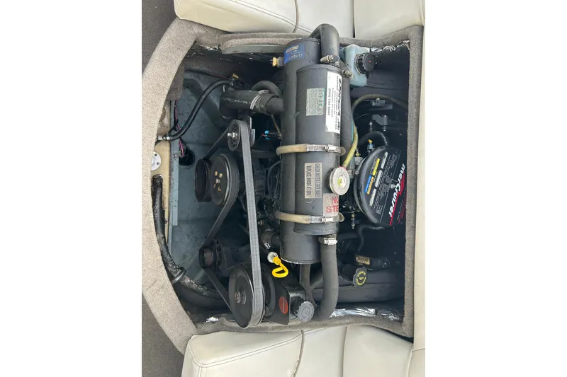 Slide: The Image of Engine compartment of a 1999 Bayliner 1850 Capri LS boat, showcasing mechanical components. - 10