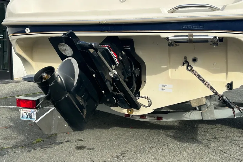 Slide: The Image of 1999 Bayliner 1850 Capri LS boat stern with outboard motor on trailer. - 12
