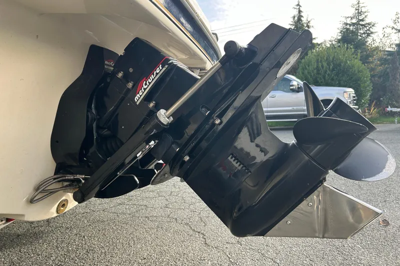 Slide: The Image of 1999 Bayliner 1850 Capri LS with MerCruiser outboard motor, parked outdoors. - 13