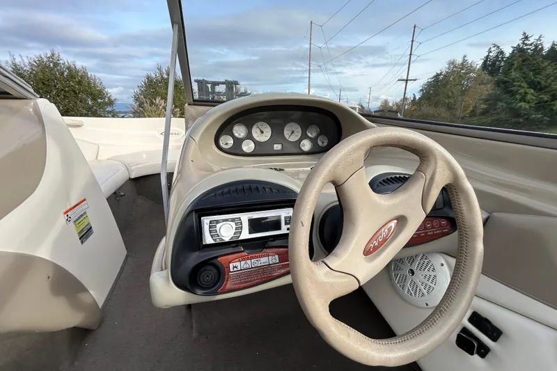 Slide: The Image of 1999 Bayliner 1850 Capri LS boat dashboard with steering wheel and instrument panel. - 4