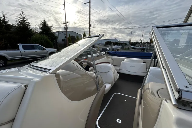 Slide: The Image of 1999 Bayliner 1850 Capri LS boat interior with white seating and open windshield. - 5