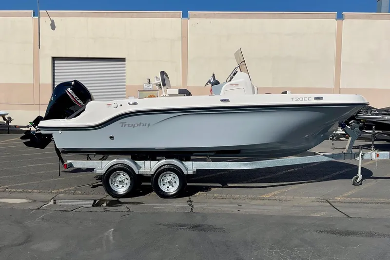 The Image of 2026 Bayliner Trophy T20CC boat on trailer, parked outdoors. - 0
