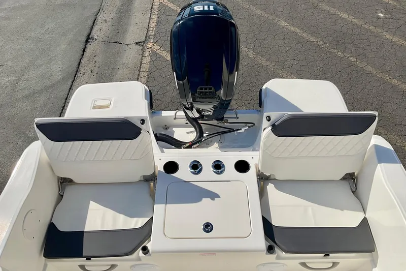 Slide: The Image of 2026 Bayliner Trophy T20CC boat interior with seating and engine view. - 13