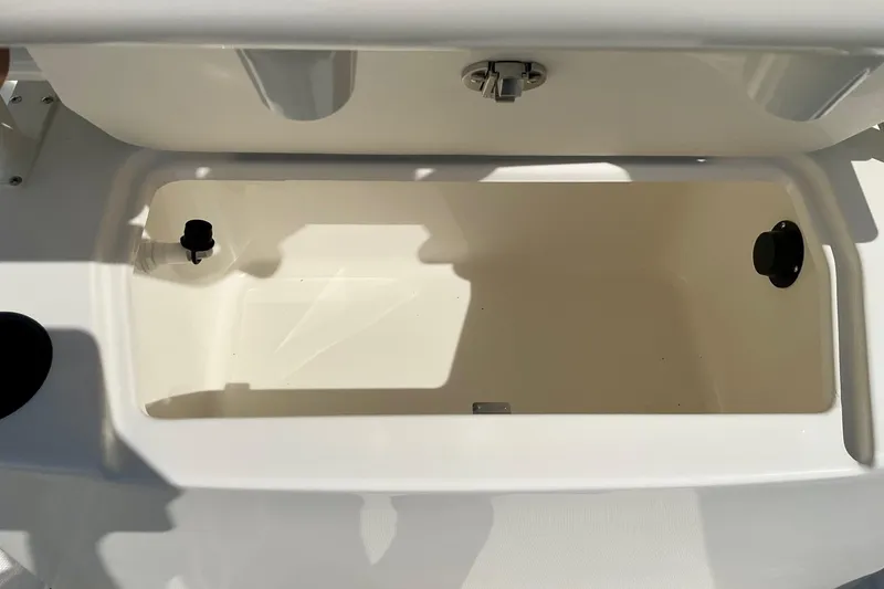 Slide: The Image of Open storage compartment on 2026 Bayliner Trophy T20CC boat, featuring a clean, white interior. - 15