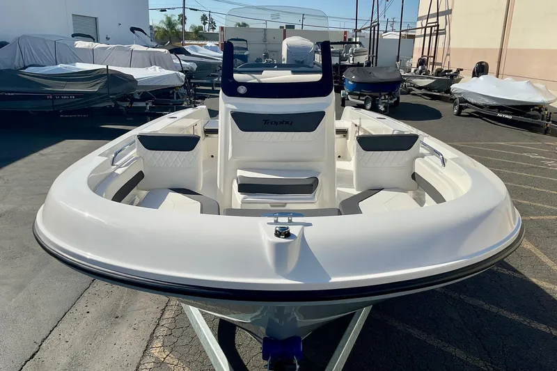 Slide: The Image of 2026 Bayliner Trophy T20CC boat in a marina, showcasing sleek design and spacious seating. - 17