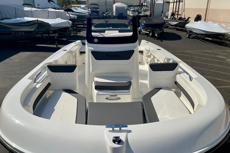 Slide: The Image of 2026 Bayliner Trophy T20CC boat interior with seating, displayed in a showroom. - 18