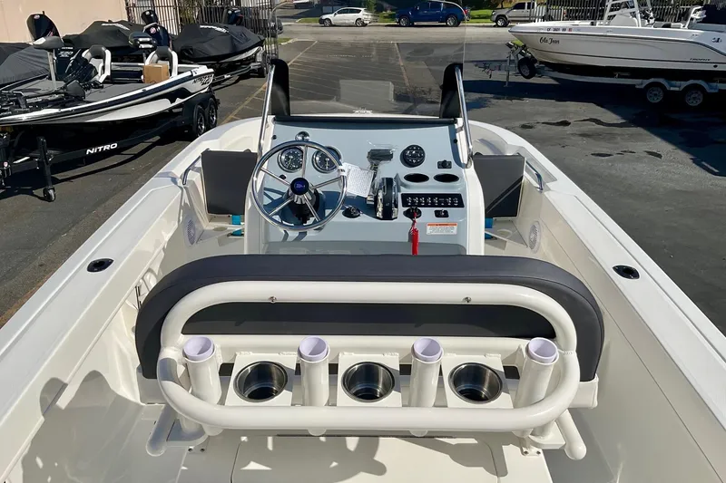 Slide: The Image of 2026 Bayliner Trophy T20CC boat interior with steering console and rod holders. - 19