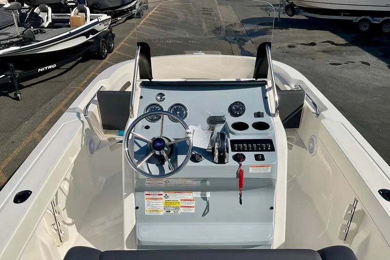 Slide: The Image of 2026 Bayliner Trophy T20CC boat dashboard with steering wheel and controls. - 20