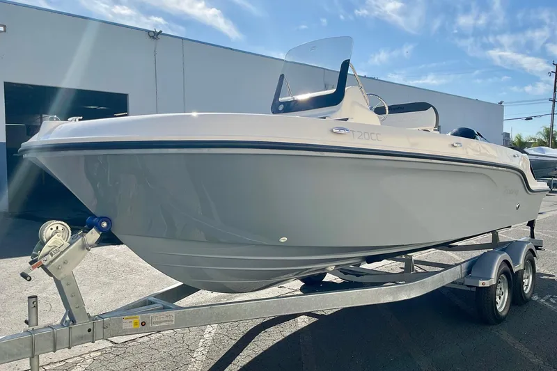 Slide: The Image of 2026 Bayliner Trophy T20CC boat on trailer under clear blue sky. - 5