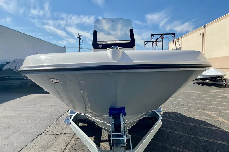 Slide: The Image of 2026 Bayliner Trophy T20CC boat on trailer, parked outdoors under blue sky. - 6