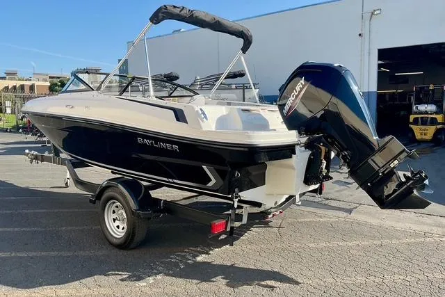 Slide: The Image of 2026 Bayliner VR4 Bowrider OB boat with outboard motor on a trailer. - 1