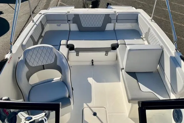 Slide: The Image of 2026 Bayliner VR4 Bowrider OB interior with white and gray seating arrangement. - 10