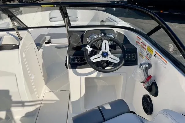 Slide: The Image of 2026 Bayliner VR4 Bowrider OB cockpit with steering wheel and dashboard controls. - 17