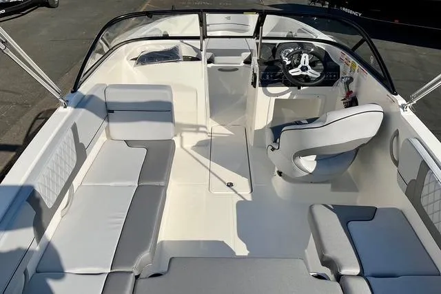 Slide: The Image of 2026 Bayliner VR4 Bowrider OB interior with sleek seating and modern steering console. - 18