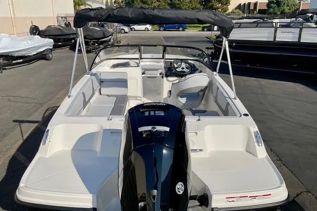 Slide: The Image of 2026 Bayliner VR4 Bowrider OB with Mercury 115 engine, parked outdoors. - 19