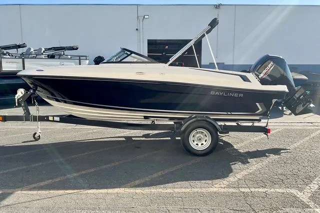 Slide: The Image of 2026 Bayliner VR4 Bowrider OB boat on trailer, parked outdoors. - 2